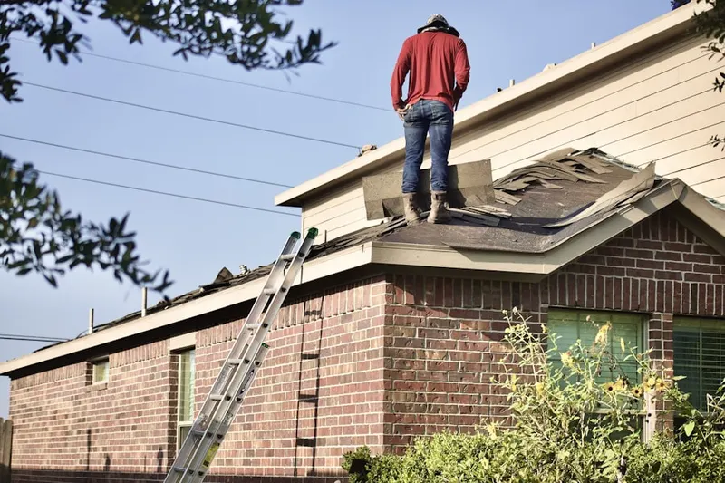 Professional roofer working on a residential roof in Dunhams Corners